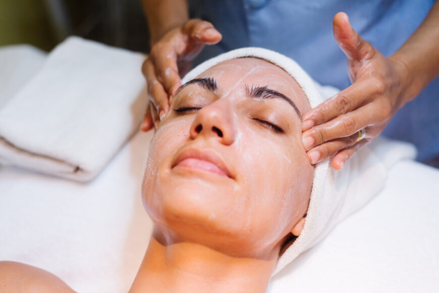 A women is doing her facial treatment